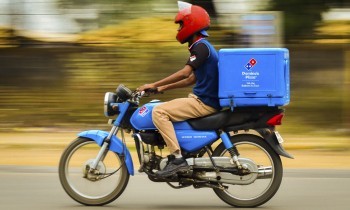 dominos pizza delivery boy on motorcycle